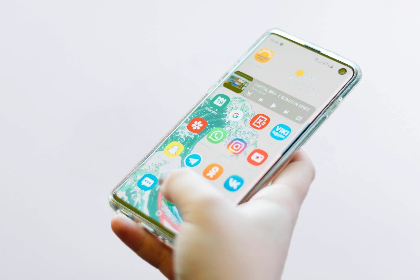 Person holding an Android smartphone full of colorful app icons, illustrating tips for freeing up phone storage