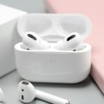 White wireless earbuds in an open charging case, illustrating budget wireless earbuds in 2026