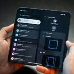 Hands holding a foldable smartphone showing its settings menu, illustrating foldable phones in 2026